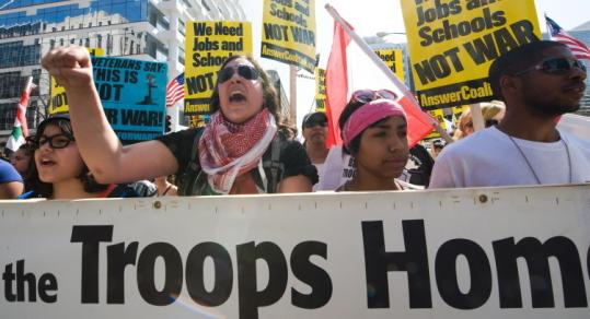 Demonstrators listened to speakers in Washington, D.C., yesterday  during an antiwar protest, which drew thousands.