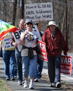Demonstrators marched in   Natick yesterday to protest US involvement in Iraq and Afghanistan.