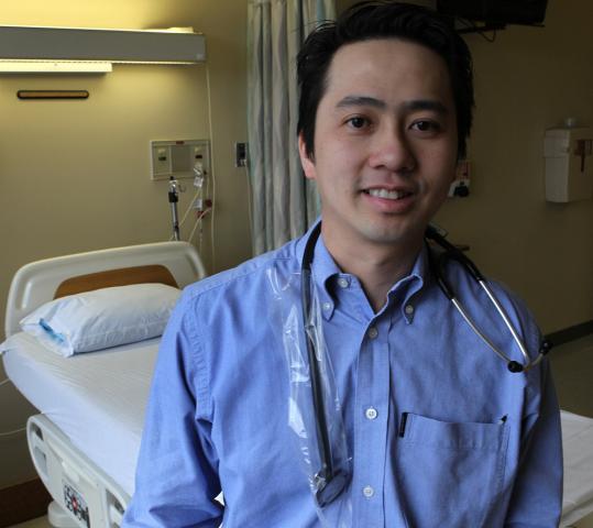 Dr. Richard Ma wears one of the stethoscope covers he invented at Saints Medical Center in Lowell.
