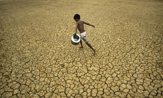 An Indian boy ran across a parched field in Berhampur,  Orissa state, India, yesterday, World Water Day, as in New Delhi, a man  dove into a polluted section of the River Yamuna to scavenge for coins  and ornaments left by Hindu rituals at the river bank. Officials say  that factories in the Indian capital are ignoring regulations and  dumping untreated sewage and industrial pollution into the river that  gives the city much of its drinking water. A UN report released  yesterday said more people die from polluted water every year than from  all forms of violence.