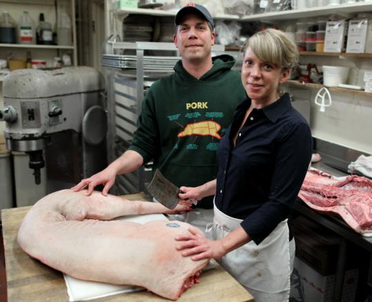 Jason Lord and Julie Biggs of Formaggio Kitchen teach demonstrations of how to butcher a pig. “It’s not freaky or daunting anymore to eat a pig’s tail,’’ says Biggs.