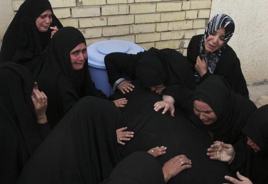 Family  members in Najaf, Iraq, mourned Karima Mohammed, 48, killed yesterday  when suicide bombers struck in Baghdad.