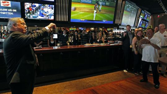 Mayor Menino throws the ceremonial first pitch to Jerry Remy at the opening of the sportscaster’s new bar and grill last night.