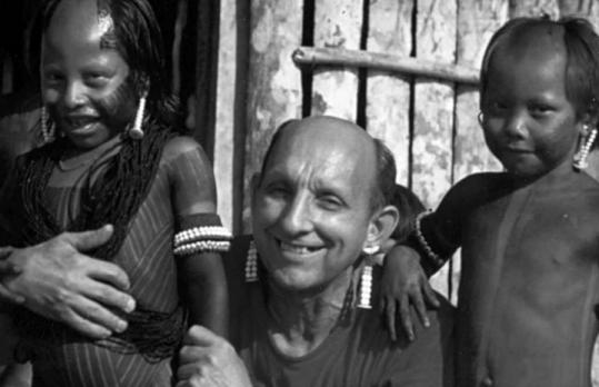 In a photo from a 2008 newsletter released by the Bresciani Missionaries, the Rev. Mario Pezzotti posed with the Kayapo Indian children he worked with in Brazil. In 1959, he had raped and abused a 14-year-old Massachusetts youth.