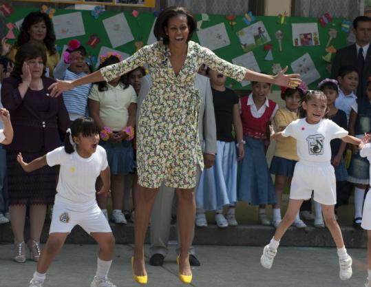 Michelle  Obama played with children at a school in Mexico City, but she also  challenged them to tackle big problems.