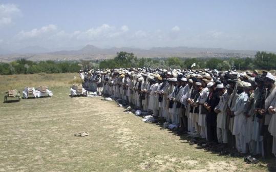 Afghans prayed  yesterday in Khost Province beside the coffins of four people killed  Monday night by NATO troops.