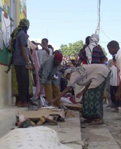 Residents examined  bodies after two explosions yesterday at a mosque in the Somali capital  of Mogadishu.