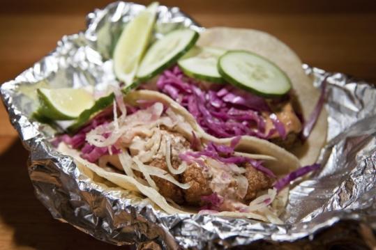 The El Pelon experience includes fish tacos with onions and cucumbers.
