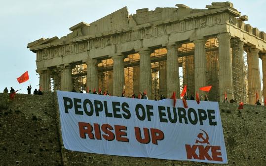 Greek Communist Party members protested at the Acropolis yesterday  against measures that will cut into civil servants’ pay.