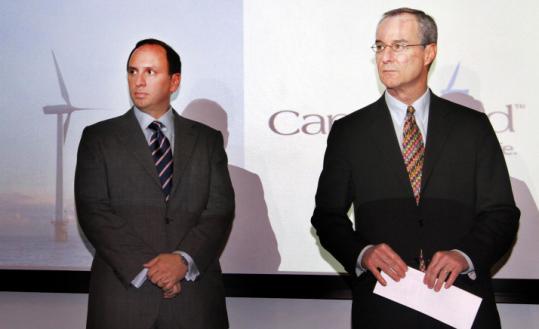 National Grid president Tom King (left) and Jim Gordon, president of Cape Wind, spoke yesterday in Waltham.