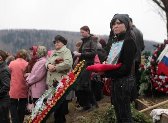 Relatives  and friends of a worker killed in the mine explosion mourned at his  funeral yesterday in Mezhdurechensk, Russia. The death toll reached 52  yesterday, with dozens still missing.