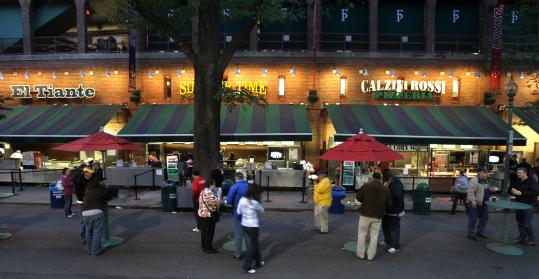 While the game goes on inside Fenway Park, ticket holders linger on Yawkey Way, watching on TV screens near the food vendors, having a less frantic time before they mosey into the park.