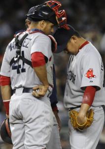 A sullen Daisuke Matsuzaka (9 hits, 7 runs in 4 2/3 innings), hangs his head as he stands with Victor Martinez before being relieved in the fifth inning.