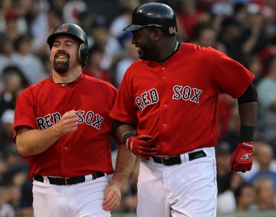 Kevin Youkilis and David Ortiz were all smiles after they scored on Victor Martinez’s double to center field in the first inning.