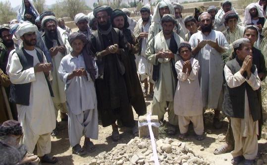 In Kandahar, Afghans prayed yesterday  over the graves of victims of the attack. At least 40 people were killed  and 77 injured in the attack on a wedding party.