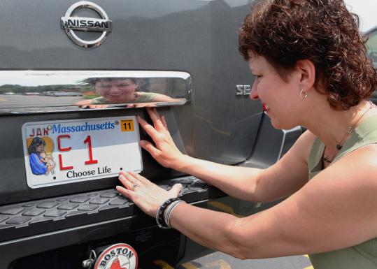 Merry Nordeen, the woman behind the new tags, put the plate on her car.