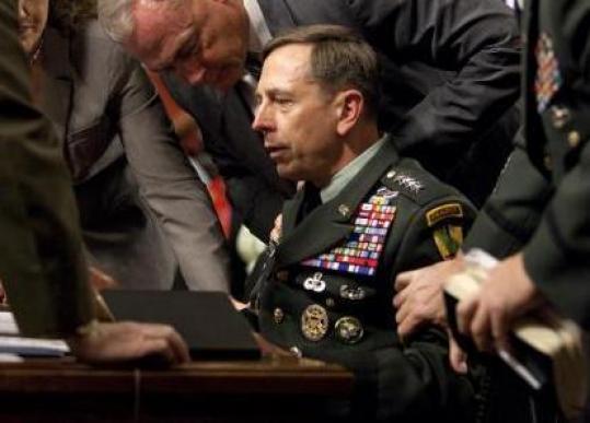 General David Petraeus is surrounded by staff after appearing to faint Tuesday.