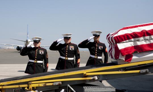 A Marine Corps honor  guard saluted yesterday as the casket of Corporal Paul Fagundes arrived  at Logan.