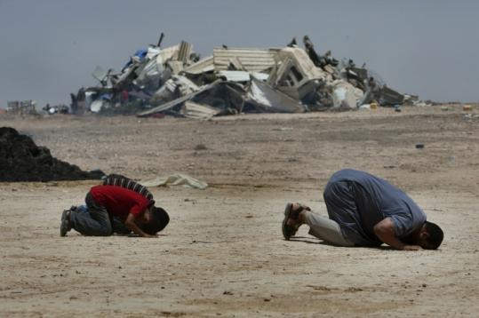 Bedouins prayed near their former home after Israel demolished buildings it says were built on state property.