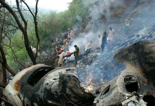 Rescue workers rushed to the crash site about 9 miles from the Islamabad airport. Fire had spread amid the thickly wooded hills.