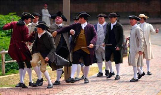 Reenactors played a scene in which angry residents of Williamsburg, Va., accosted a Colonial tax collector.