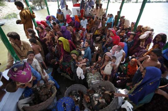 Evacuated flood victims crowded a naval boat Sunday in Sukkur, in Pakistan’s Sindh Province. Navy boats sped across flood waters as the military took a lead role in rescuing the survivors.