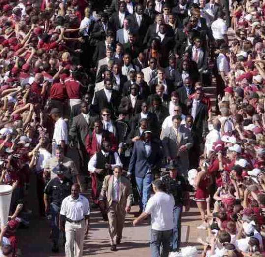Thousands of students cheered on coach Nick Saban and the Alabama Crimson Tide before their first game this season. Saban is one of the college coaches who makes millions a year.