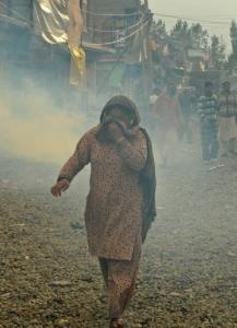 A Kashmiri woman shielded her face from tear gas yesterday during a clash between police and demonstrators in Srinagar.
