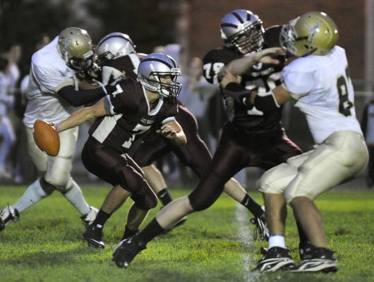 Westford Academy quarterback Patrick Dugan looks for a receiver in the game 