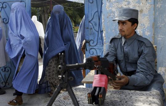An Afghan police officer kept watch at a polling station in Jalalabad yesterday. The Taliban launched a series of deadly attacks during the parliamentary election, which is considered a crucial test for the government and security forces.