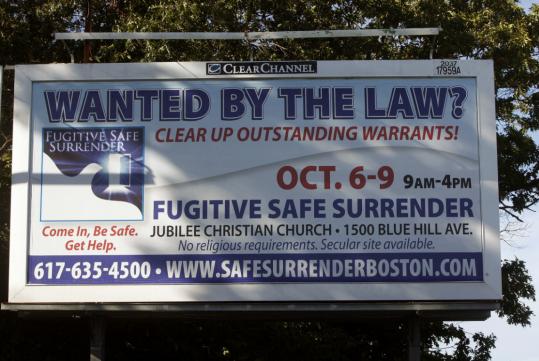 Officials hope this Blue Hill Avenue billboard will draw people wanted for minor offenses to Fugitive Safe Surrender, a program of special court hearings to be held at a Mattapan church.