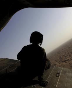 The crew chief of a US Army Chinook helicopter sat on the tail ramp of his craft, which is used to transport US and Afghan soldiers in the Zhari District in southern Afghanistan.