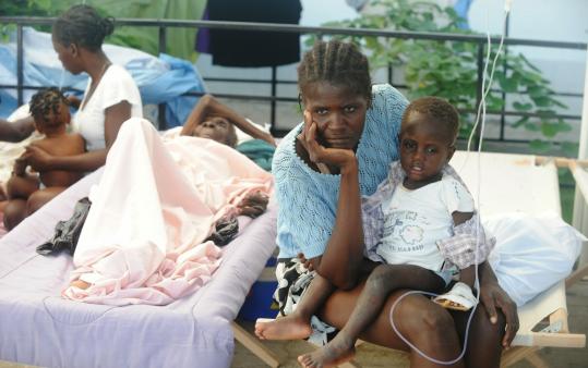 Patients were treated yesterday at a hospital in St. Marc, Haiti, where the cholera outbreak that has claimed 250 lives began.
