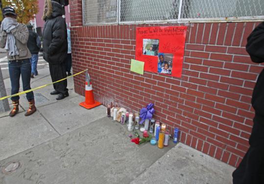 Friends and family of Thomas Whitley, who was stabbed to death Saturday, erected a shrine in his memory outside Gina’s Grocery in Roxbury yesterday.
