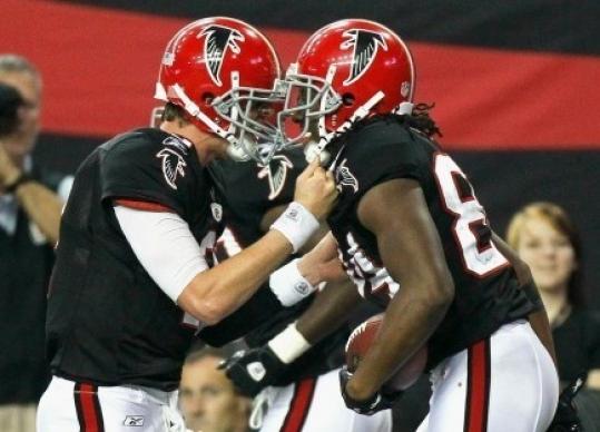 Atlanta’s Matt Ryan (left) and Roddy White celebrate their 33-yard winning touchdown pass play.