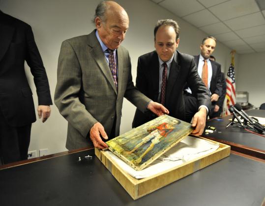 Michael Bakwin (left), and Assistant US Attorney Jack Pirozzolo, at a news conference in Boston yesterday, unpacked one of the Jean Jansem works that was stolen from Bakwin’s home in 1978.