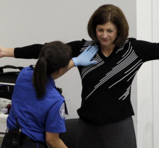A woman experiences a pat-down at the Seattle-Tacoma airport.