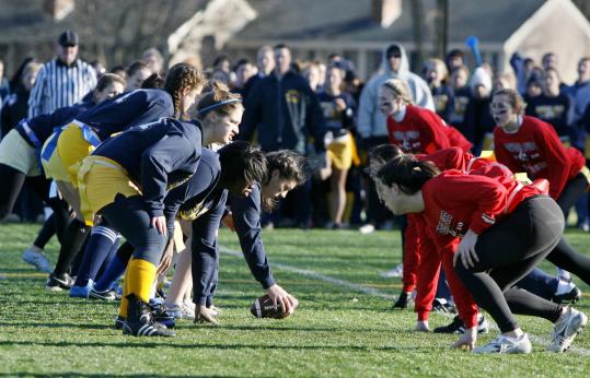 The Needham offense (left) lined up against Wellesley during the girls’ powder puff football game yesterday.