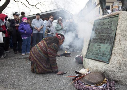 Juan Gonzalez of Boston kindled a fire under the statue of Massasoit in a prayer ritual during the 41st National Day of Mourning in Plymouth yesterday.