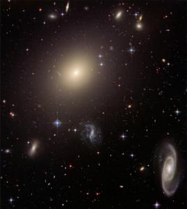 A study that suggests there are three times more stars in the universe than previously thought focused on elliptical galaxies such as the one near the center of this photo.