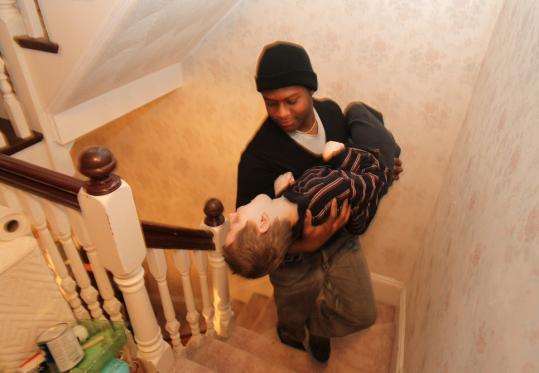 Rudy Favard, 17, cradled Sammy Parker, 8, as he carried him upstairs.