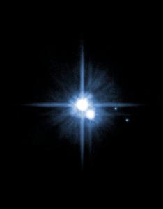 An image taken by the Hubble Space Telescope shows Pluto (center) with its newly named moons.