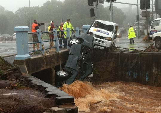 A flash flood swept vehicles against a bridge on a street in Toowoomba, about 65 miles west of Brisbane, Australia, yesterday.