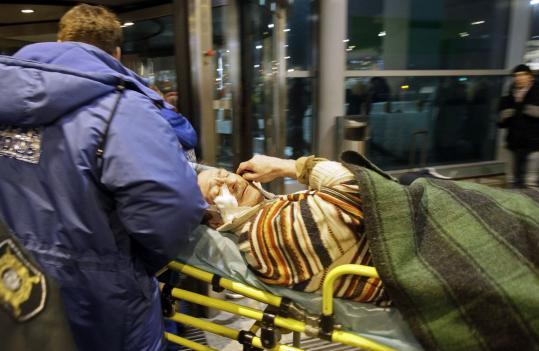 A wounded man was carried away at Domodedovo Airport. A Russian aide said a suicide bomber probably set off the blast.