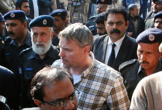 Pakistani police escorted Raymond Davis to a court in Lahore yesterday. He was arrested on murder charges after the shooting of two motorcyclists he said tried to rob him.