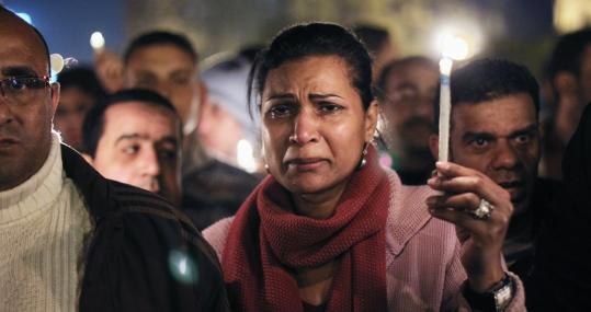 An antigovernment protester wept during a candlelight vigil yesterday for those killed during the uprising in Tahrir Square.