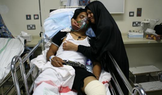 In Manama, Bahrain, a woman visited her son after at least three died and hundreds were injured in the capital’s Pearl Square.