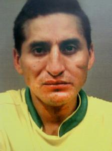 Authorities say Luis Guaman, in this police photo, used a stolen passport to board a flight to Ecuador last month.