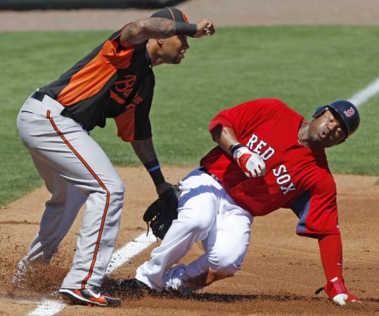 Carl Crawford stole his first two bases of the spring, here beating the throw to Orioles third baseman Josh Bell.