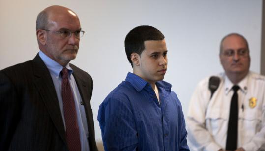 Jason Aquino (center) and his attorney, Matthew Kamholtz, listened to Superior Court Judge Howard Whitehead in Middlesex Superior Court in Woburn yesterday. Aquino will serve 18 to 20 years for the shooting of Justin D. Cosby in a Harvard dormitory.